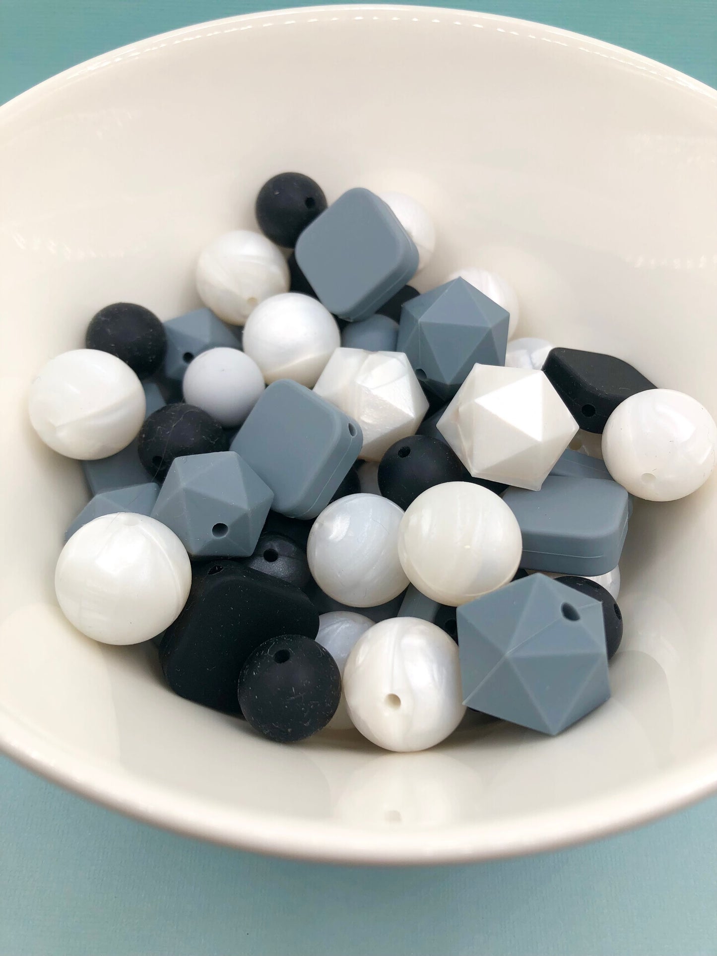 Variety pack of mixed size and shape silicone beads in monotone and pearlescene.