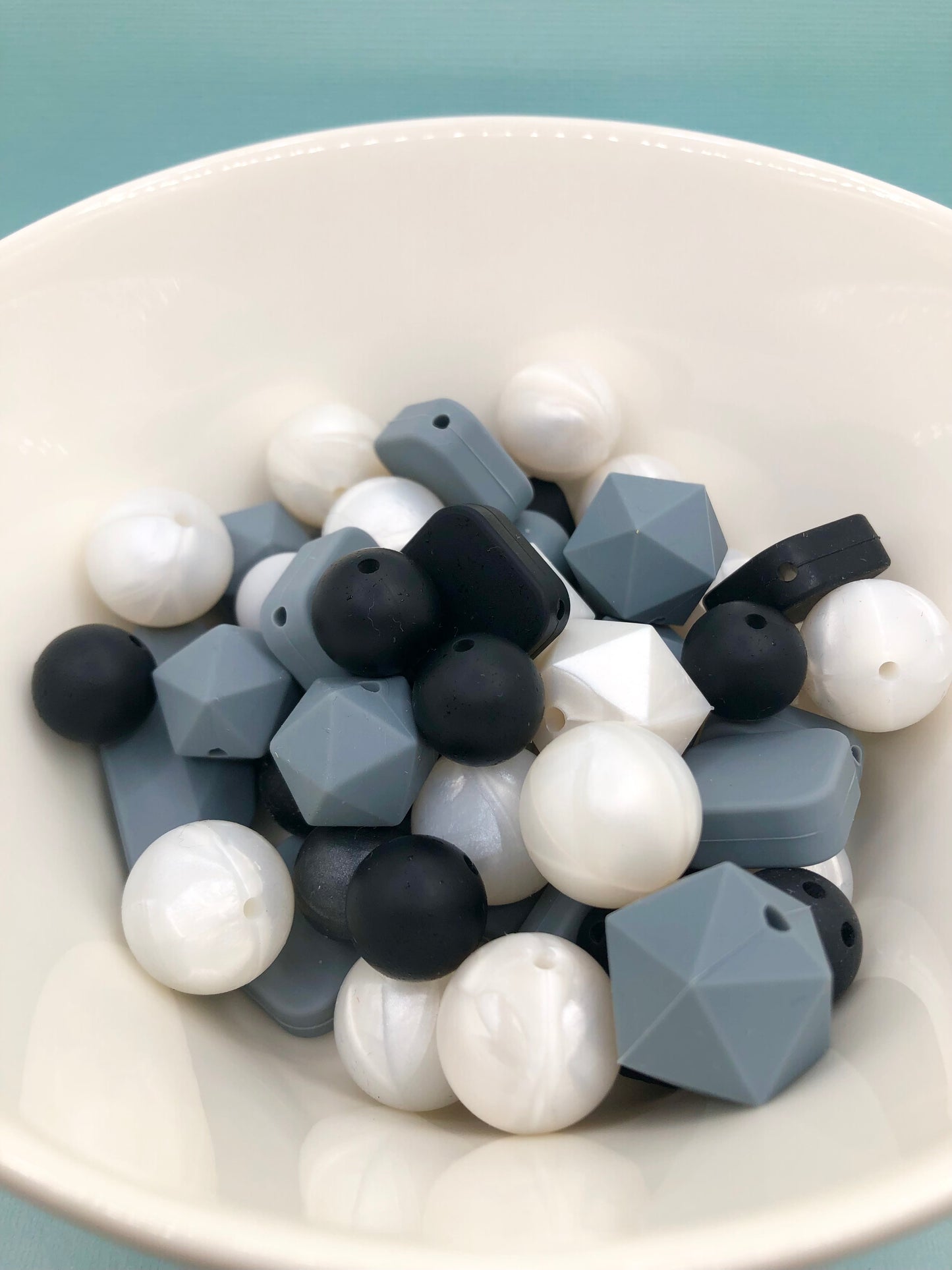 Variety pack of mixed size and shape silicone beads in monotone and pearlescene.