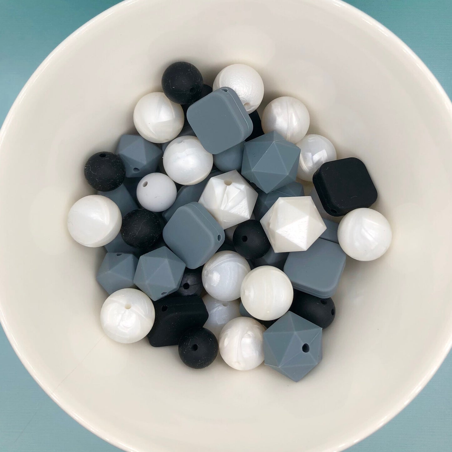 Variety pack of mixed size and shape silicone beads in monotone and pearlescene.