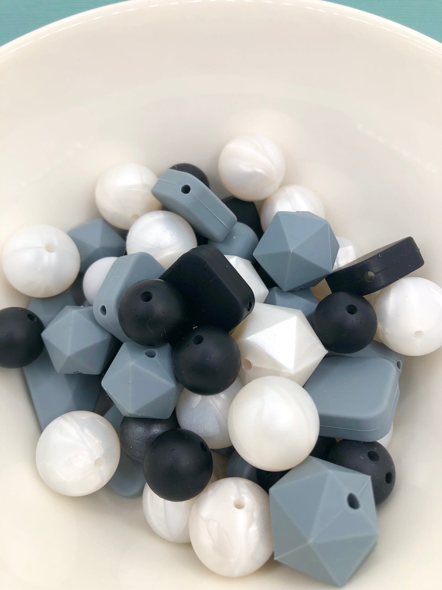 Variety pack of mixed size and shape silicone beads in monotone and pearlescene.