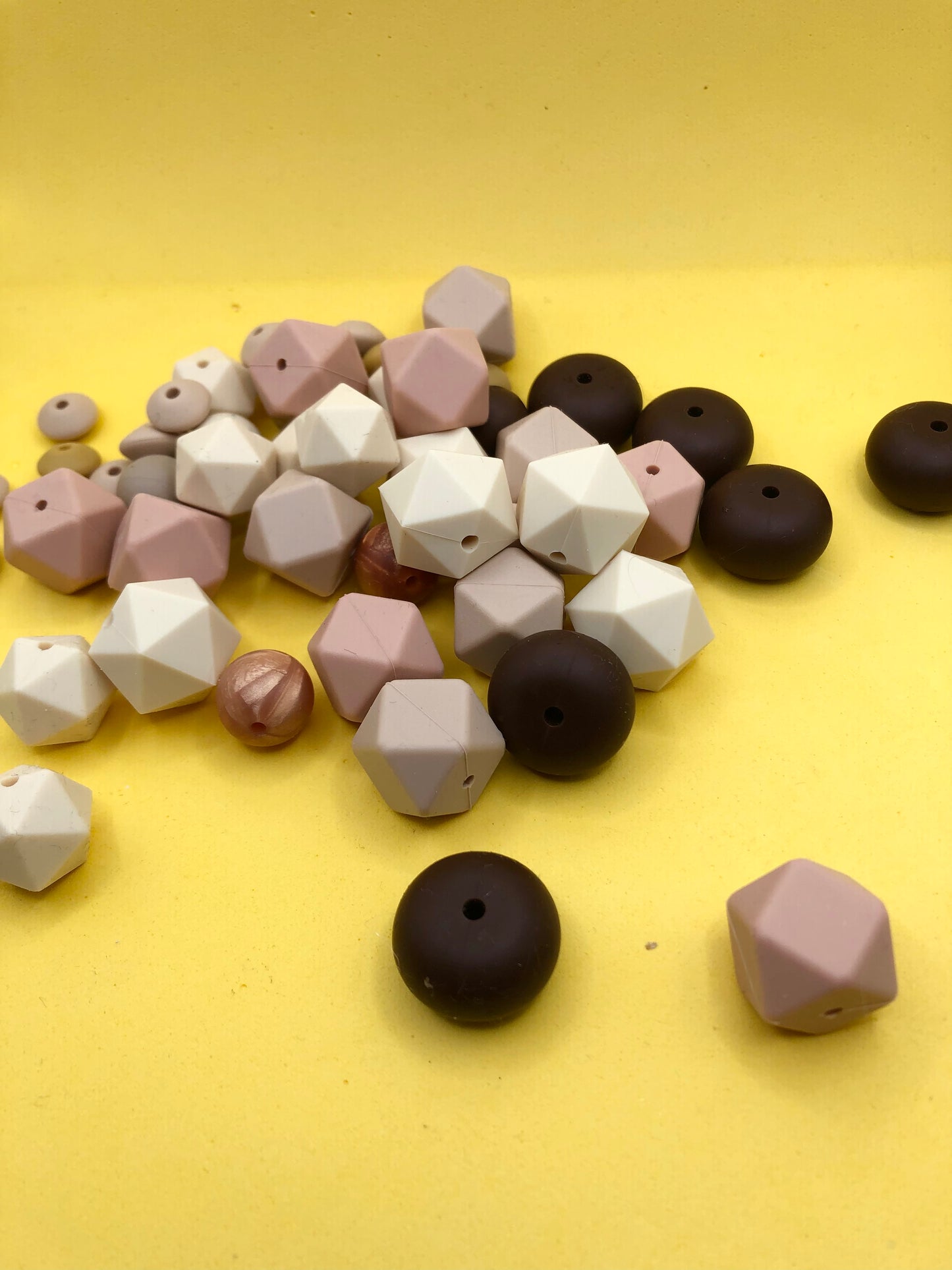 Variety pack of mixed size and shape silicone beads in various earth tones.
