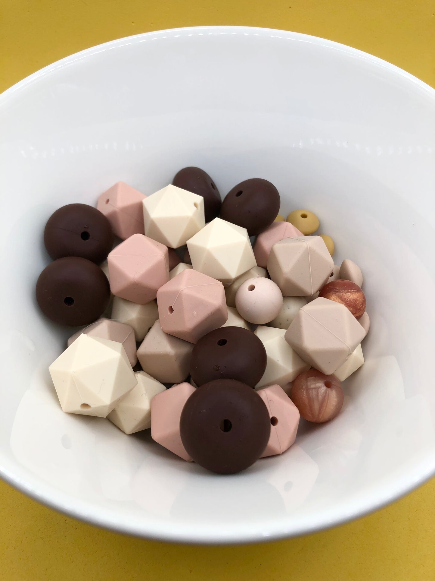 Variety pack of mixed size and shape silicone beads in various earth tones.