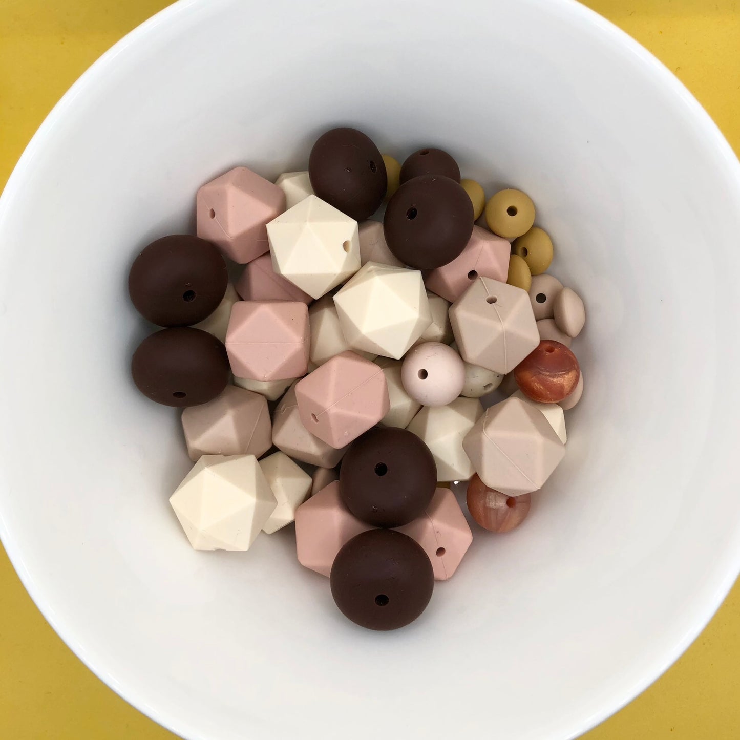 Variety pack of mixed size and shape silicone beads in various earth tones.