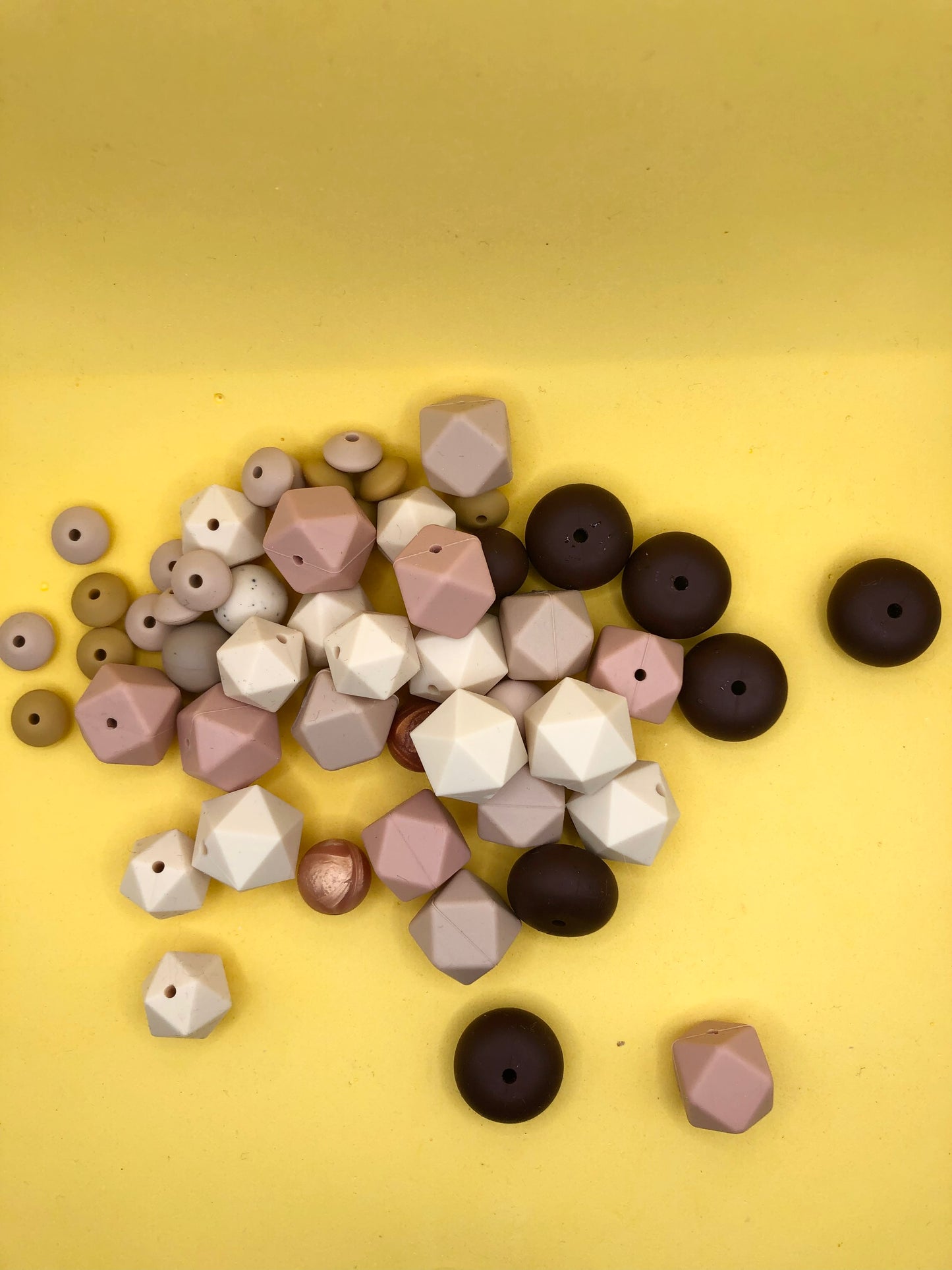 Variety pack of mixed size and shape silicone beads in various earth tones.