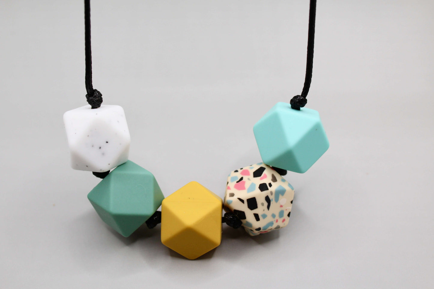 Silicone hexagon bead necklace with customizable colors, ideal for sensory needs, ADHD, and autistic adults. Baby-friendly design.