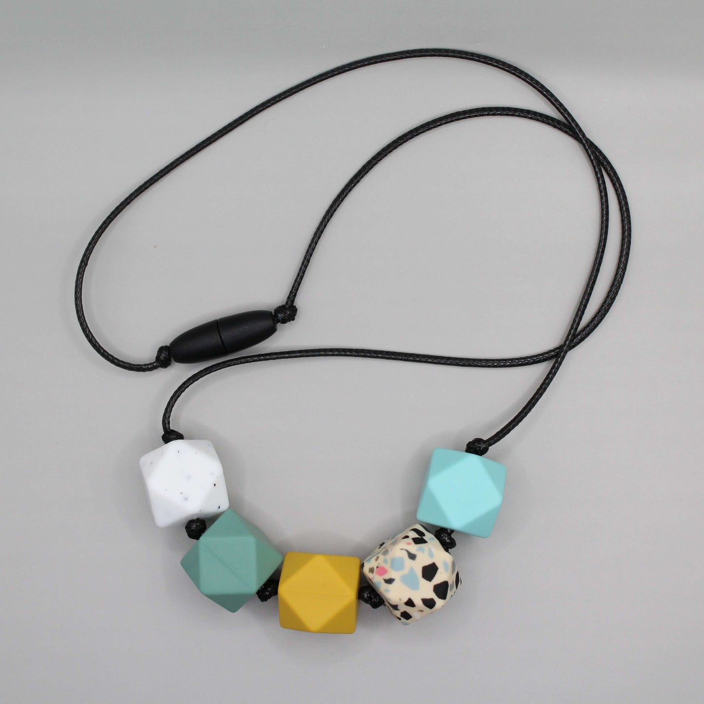 Hexagon silicone necklace with black cord, featuring 17mm colorful hexagon beads, suitable for sensory needs, ADHD, and Autistic adults.
