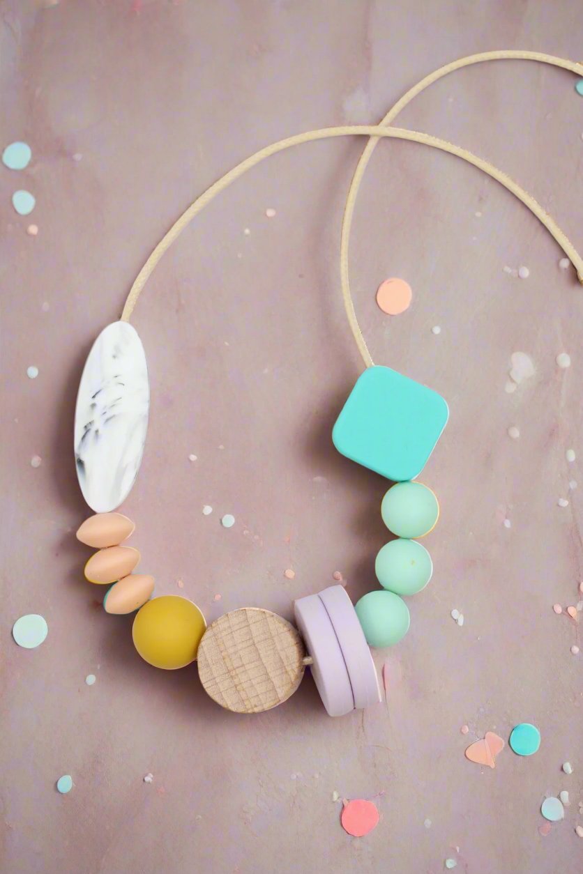 Silicone mixed bead necklace laying flat with pastel confetti