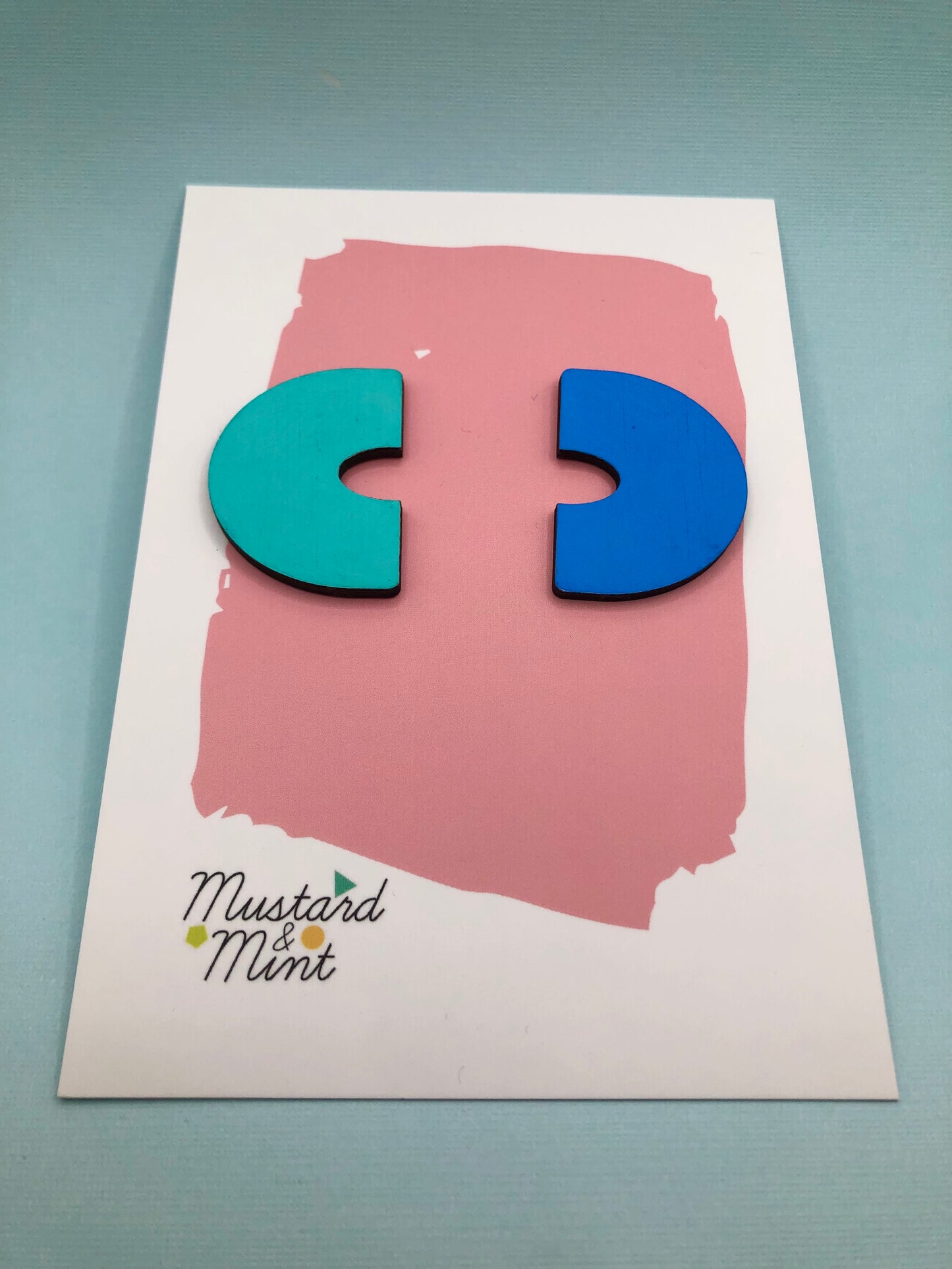 Hand painted laser cut wood oversized earrings in mismatched neon and pastel yellow.