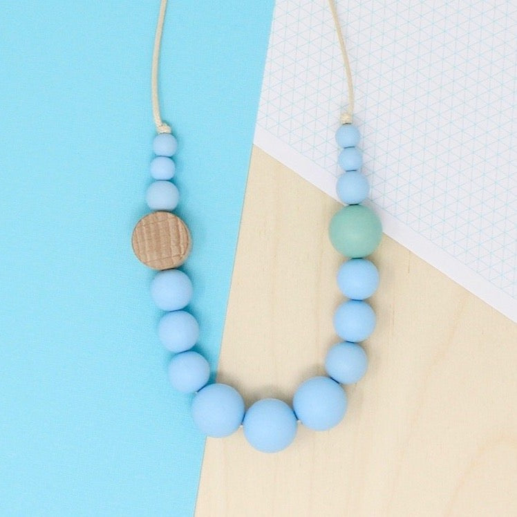 Silicone beaded necklace in aquamarine blue, neurodivergent and baby friendly for use sensory seeking and safe for use as teething and feeding jewellery.